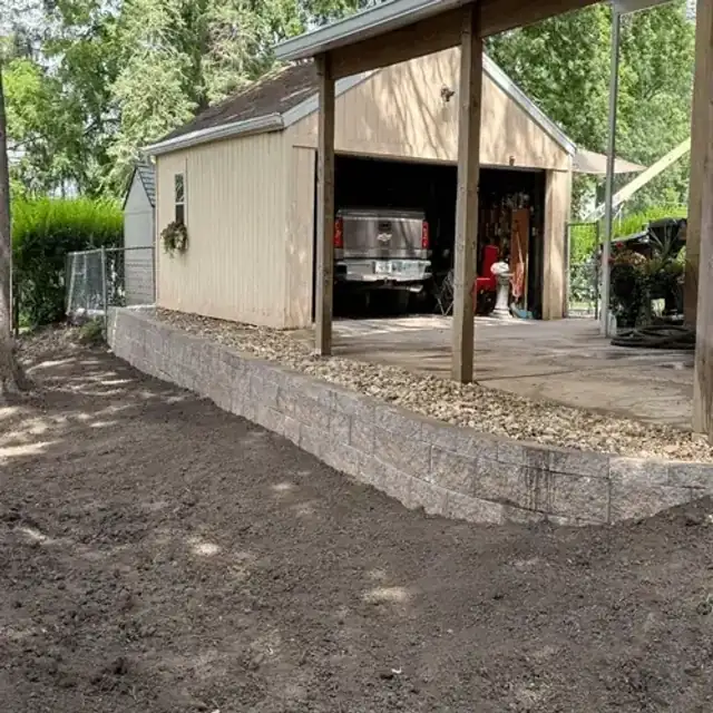 Finished retaining wall with graded yard