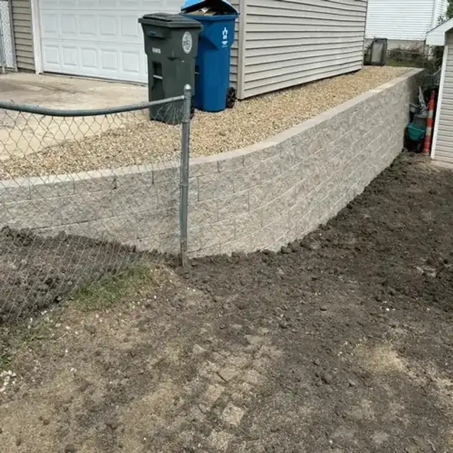 Retaining wall after installation with landscaping