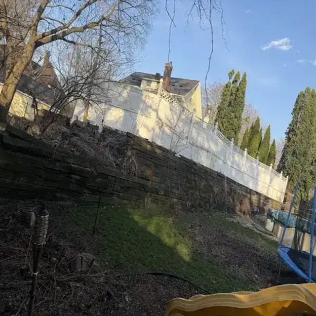 Sloped yard before retaining wall installation in Cedar Falls
